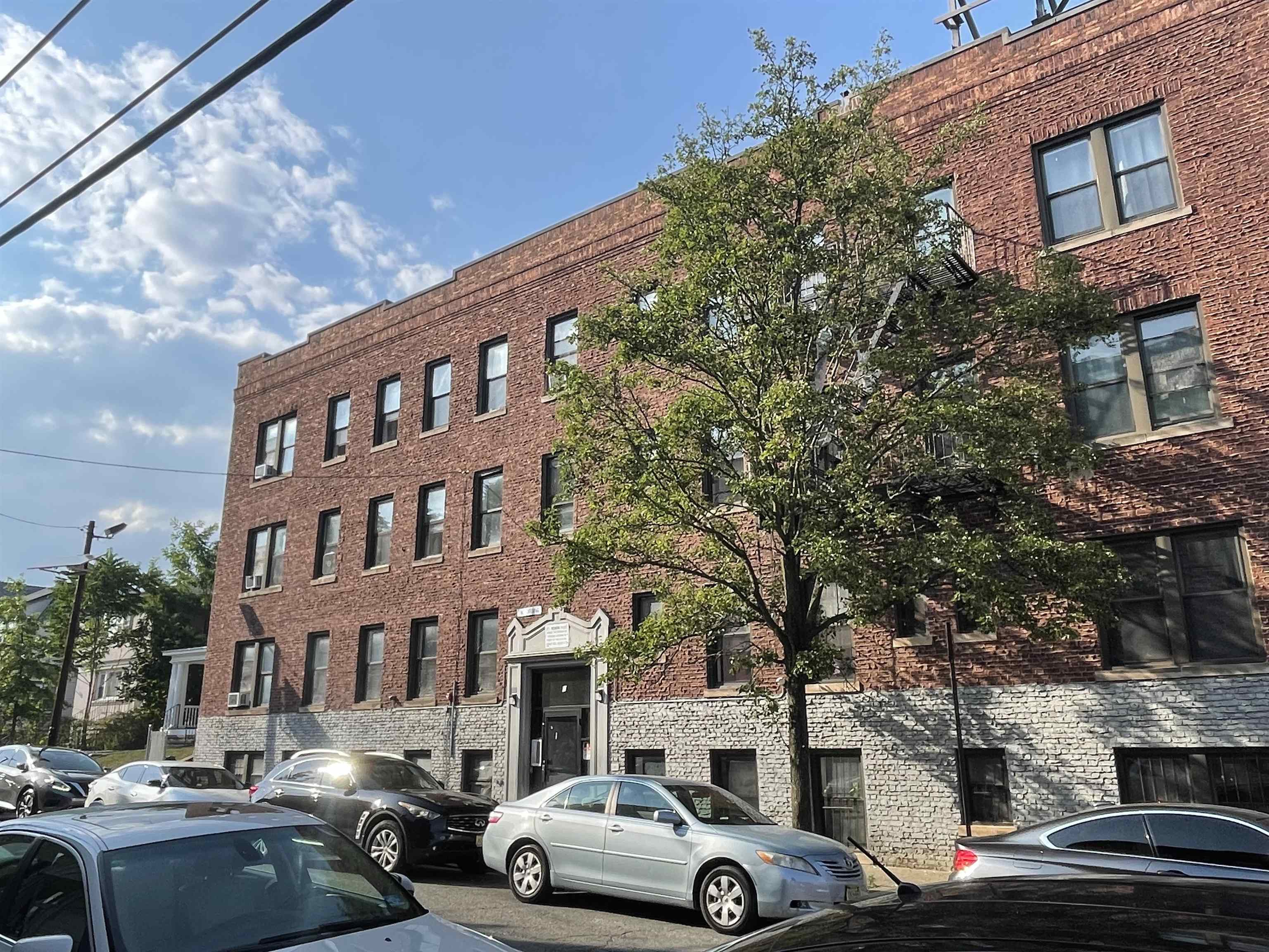 1 Noll Place, Unit 2 Newark, NJ 07106 - Photo 1 of 10 a front view of a building with cars parked
