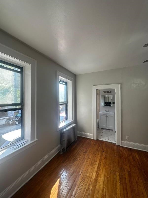 1 Noll Place, Unit 2 Newark, NJ 07106 - Photo 7 of 10 a view of an empty room with wooden floor and a window