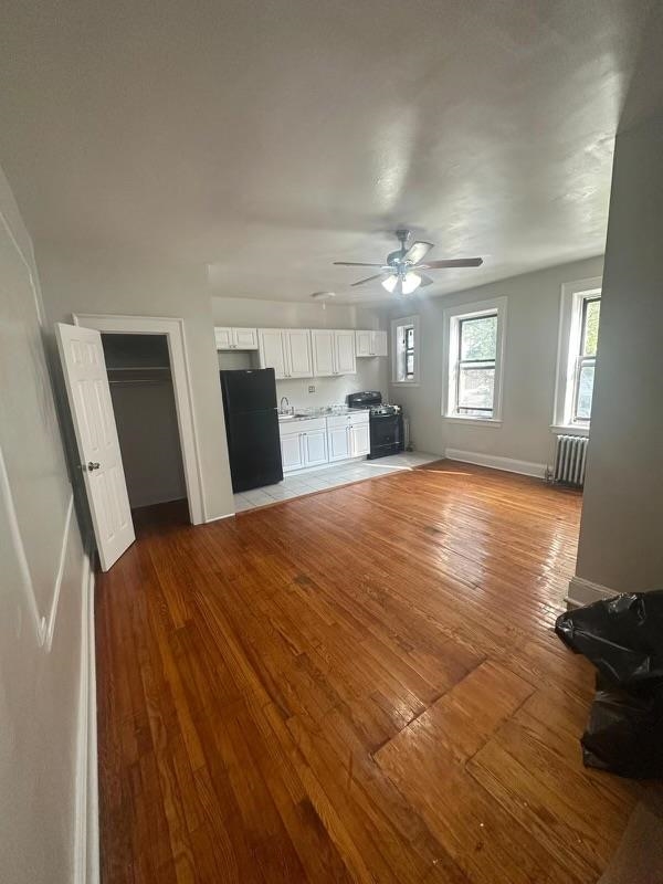 1 Noll Place, Unit 2 Newark, NJ 07106 - Photo 9 of 10 a large room with chandelier fan and windows