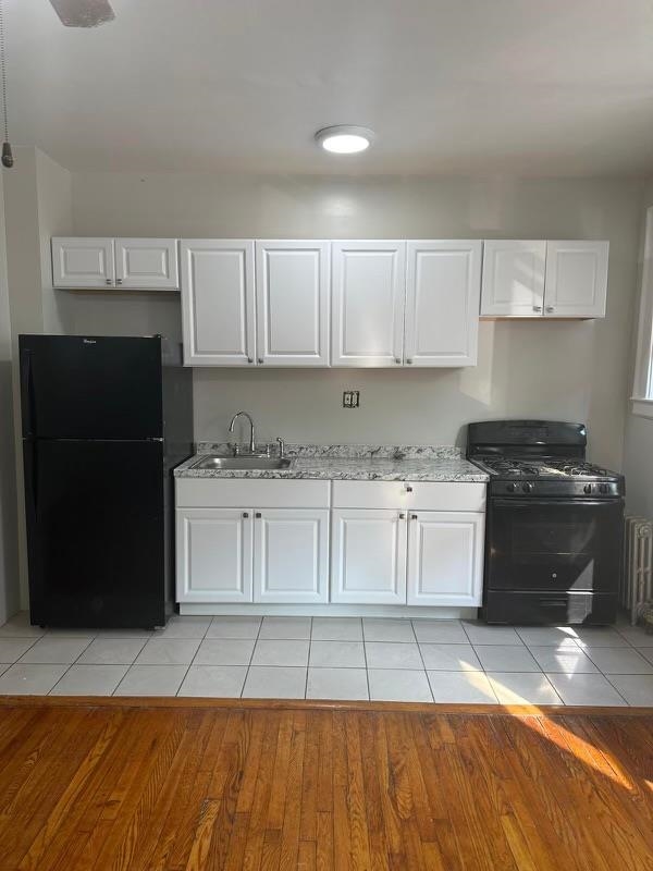 1 Noll Place, Unit 2 Newark, NJ 07106 - Photo 10 of 10 a kitchen with granite countertop a refrigerator stove and white cabinets