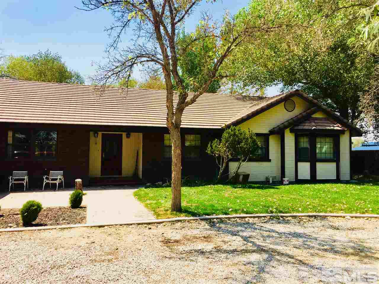 2277 Soda Lake Road Fallon, NV 89406 - Photo 1 of 25 a view of a house with a yard and potted plants