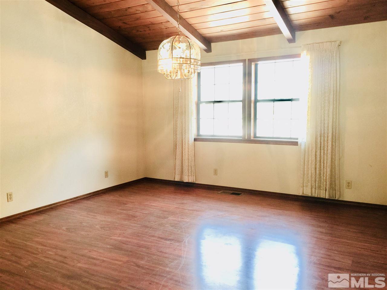 2277 Soda Lake Road Fallon, NV 89406 - Photo 5 of 25 an empty room with wooden floor and windows