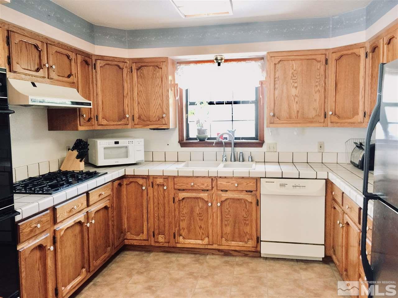 2277 Soda Lake Road Fallon, NV 89406 - Photo 6 of 25 a kitchen with stainless steel appliances granite countertop a sink stove and cabinets