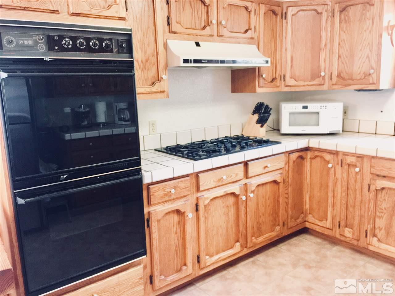 2277 Soda Lake Road Fallon, NV 89406 - Photo 7 of 25 a kitchen with stainless steel appliances granite countertop a stove and a microwave