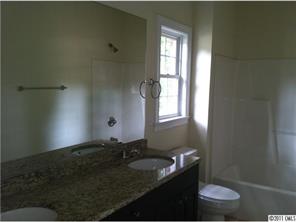 161 Rushing Water Lane Troutman, NC 28166 - Photo 8 of 14 a bathroom with a granite countertop sink and a toilet