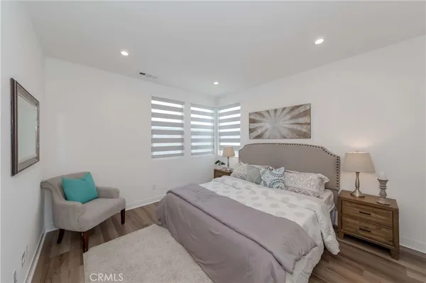 a bedroom with a bed and a large window