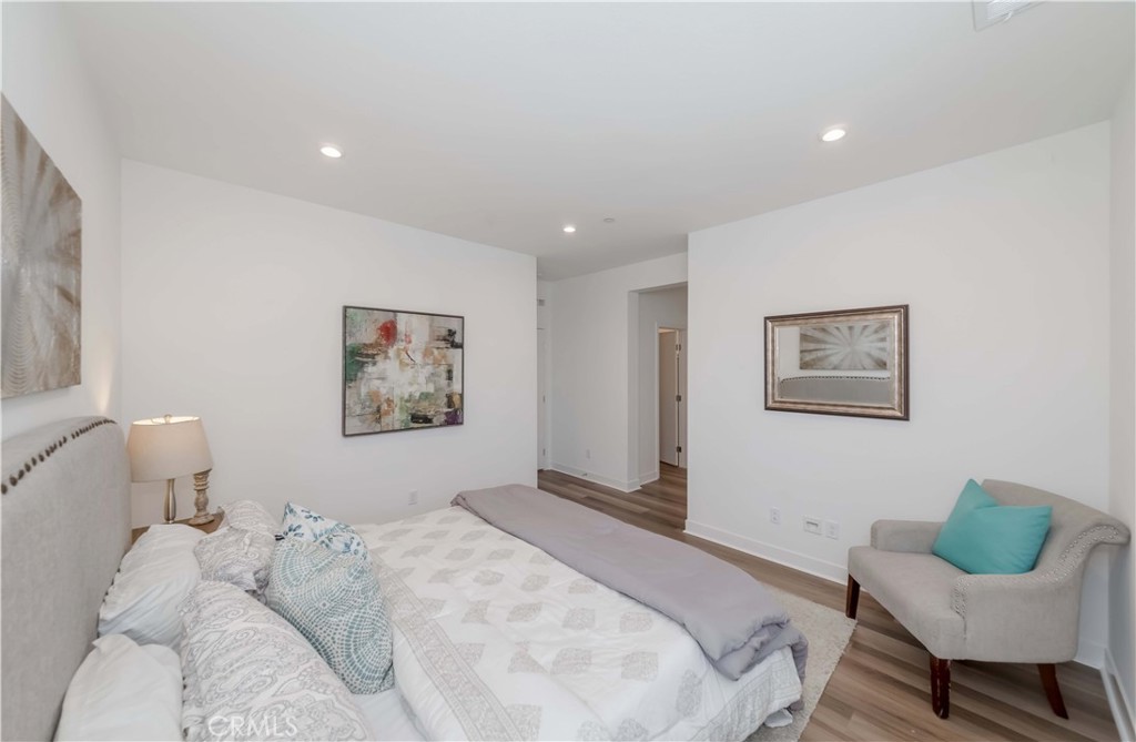 1403 West Bushell Street Anaheim, CA 92805 - Photo 17 of 34 a bedroom with a bed and chair