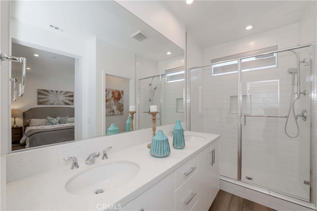 1403 West Bushell Street Anaheim, CA 92805 - Photo 18 of 34 a bathroom with a shower sink vanity and mirror