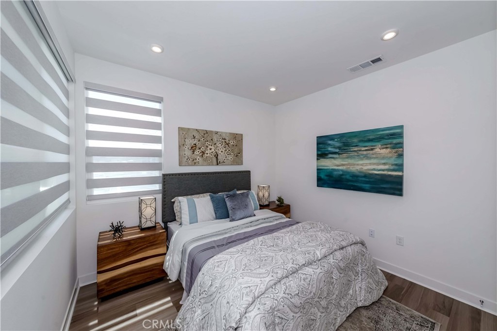 1403 West Bushell Street Anaheim, CA 92805 - Photo 19 of 34 a bedroom with a bed and a painting on the wall