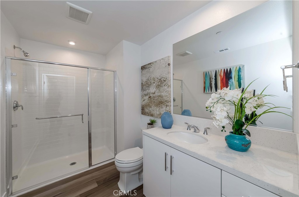 1403 West Bushell Street Anaheim, CA 92805 - Photo 20 of 34 a bathroom with a shower a toilet and a sink
