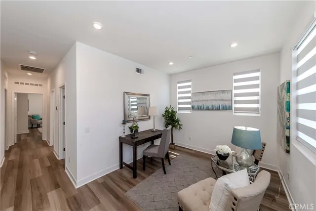 a living room with furniture and a potted plant