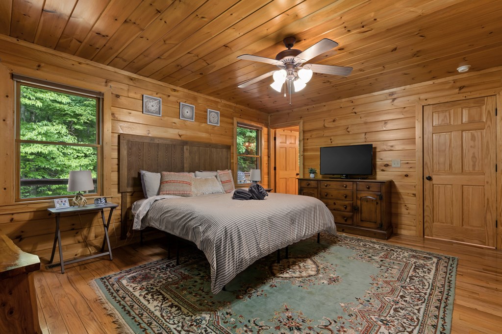 220 Solar Drive Blue Ridge, GA 30513 - Photo 19 of 59 a large bedroom with a bed and a flat screen tv