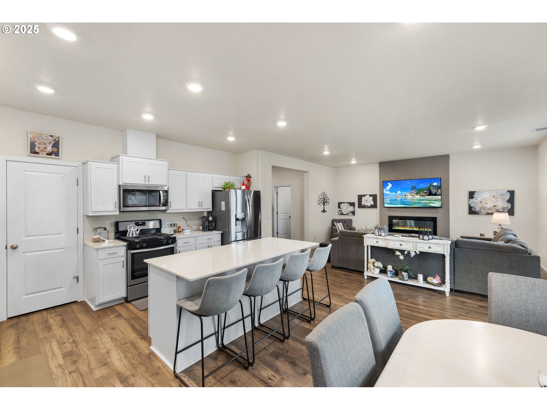 371 Himalaya Street Salem, OR 97301 - Photo 11 of 34 a living room with stainless steel appliances furniture a flat screen tv and a kitchen view