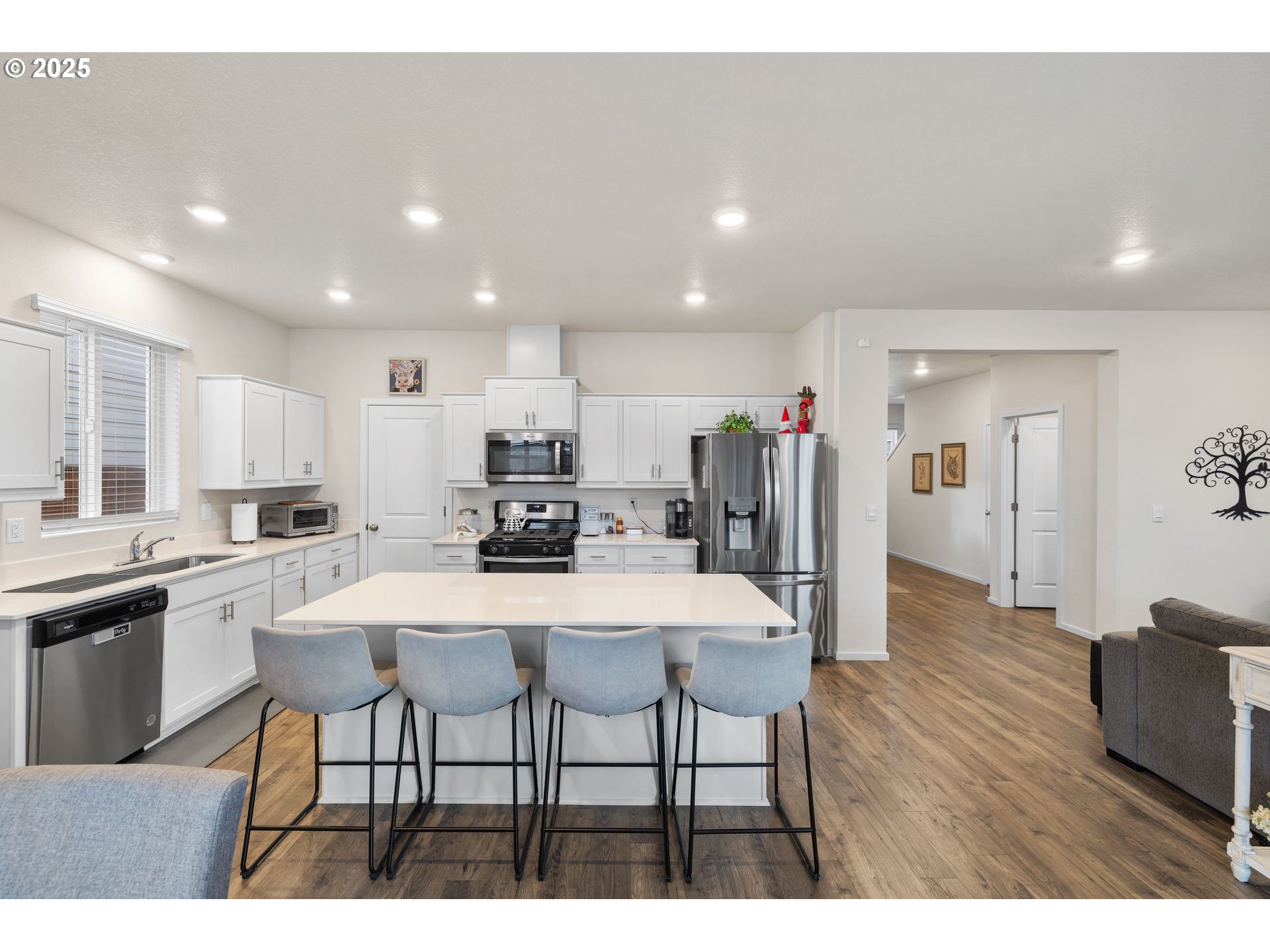 371 Himalaya Street Salem, OR 97301 - Photo 15 of 34 a kitchen with stainless steel appliances kitchen island granite countertop a dining table chairs and refrigerator