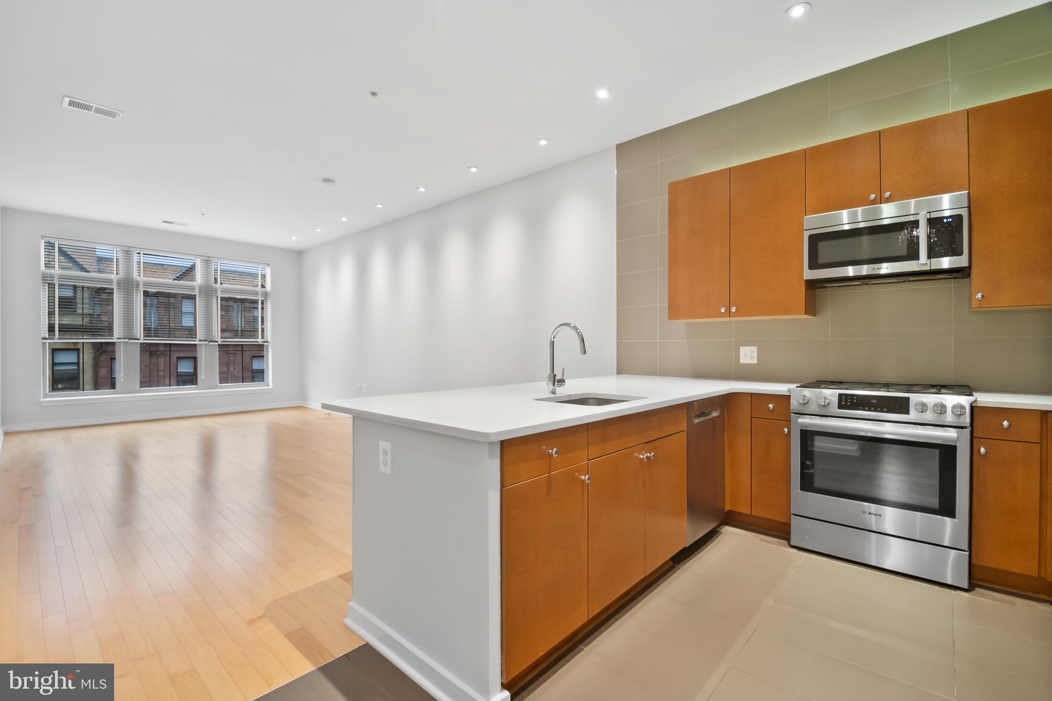 a kitchen with stainless steel appliances granite countertop a stove and a sink