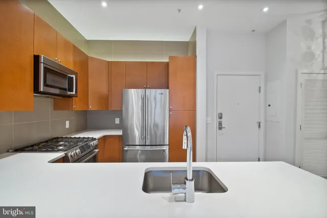 a spacious bathroom with a sink and mirror
