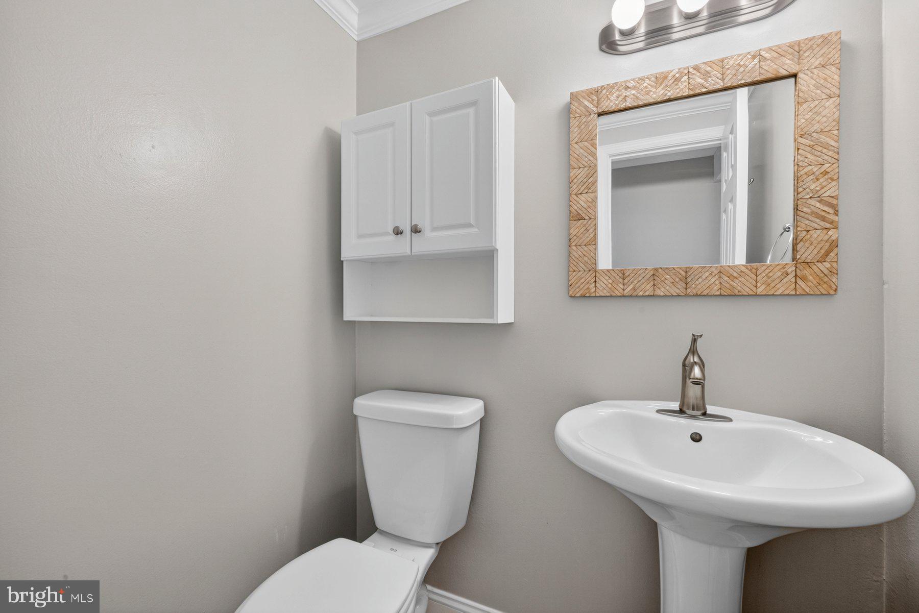 7518 Candytuft Court Springfield, VA 22153 - Photo 16 of 47 a bathroom with a toilet sink and mirror