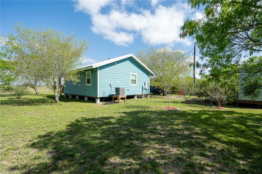 726 3rd Street Bayside, TX 78340 - Photo 24 of 40 a view of a house with a big yard plants and large trees