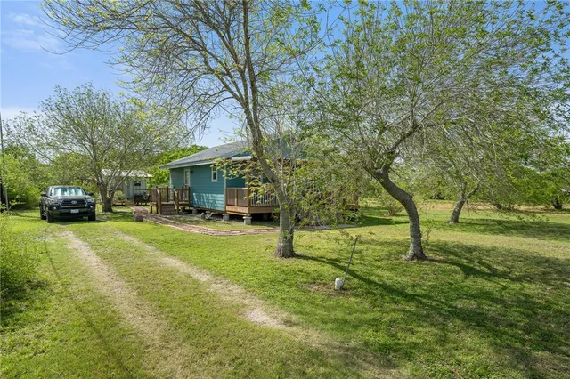 a view of a house with a yard