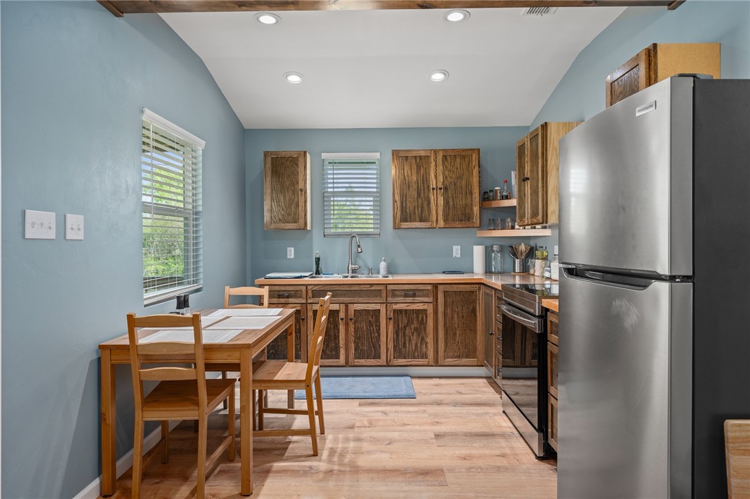 726 3rd Street Bayside, TX 78340 - Photo 9 of 40 a kitchen with a refrigerator a sink and a stove