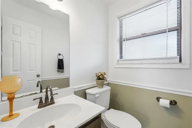 a front view of house with yard and trees in the background