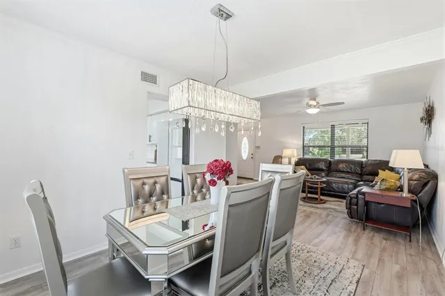 a kitchen with a sink a refrigerator and cabinets