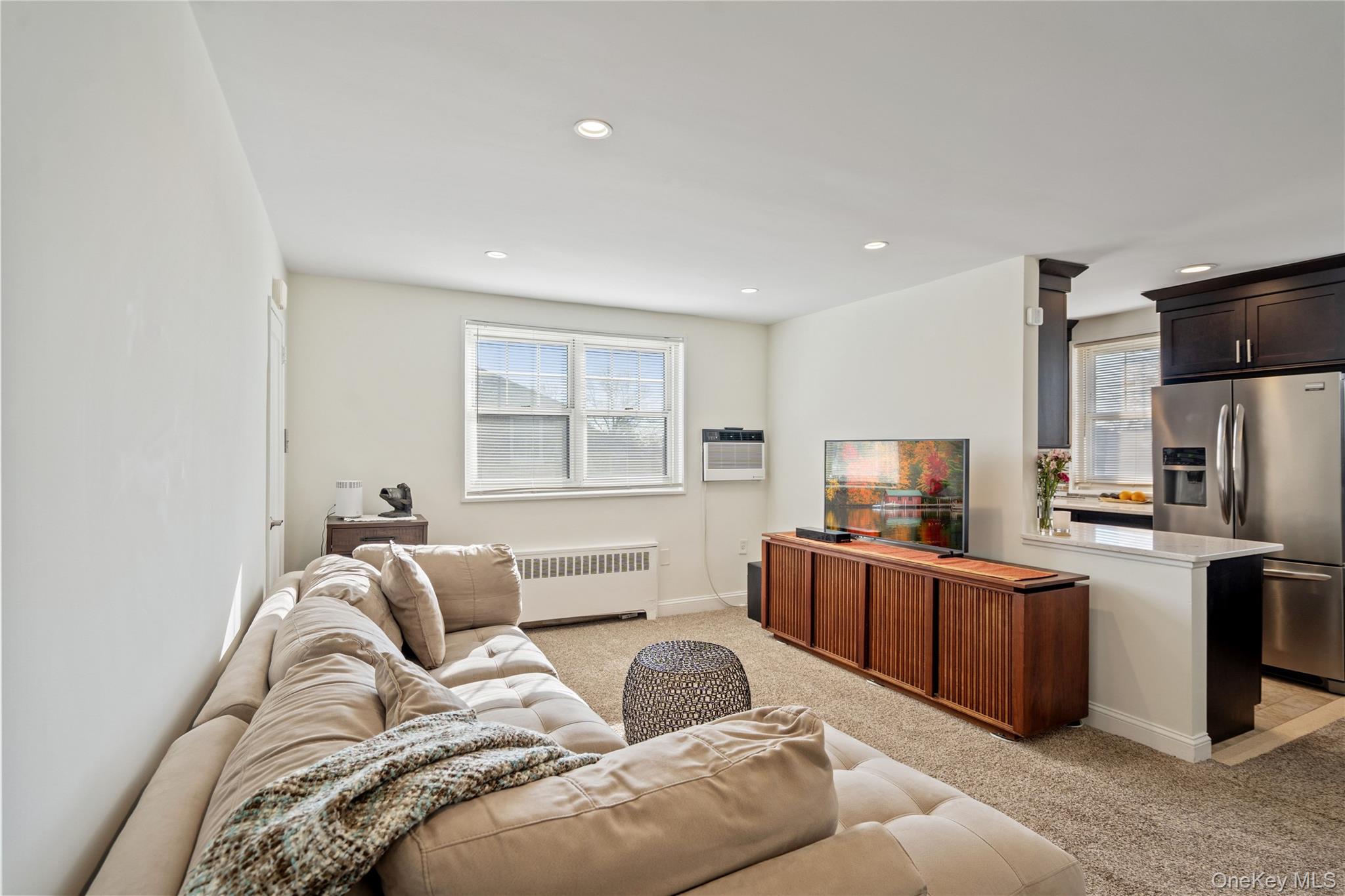 63-09 252nd Street, Unit 41322 Queens, NY 11362 - Photo 12 of 25 a living room with furniture and a flat screen tv