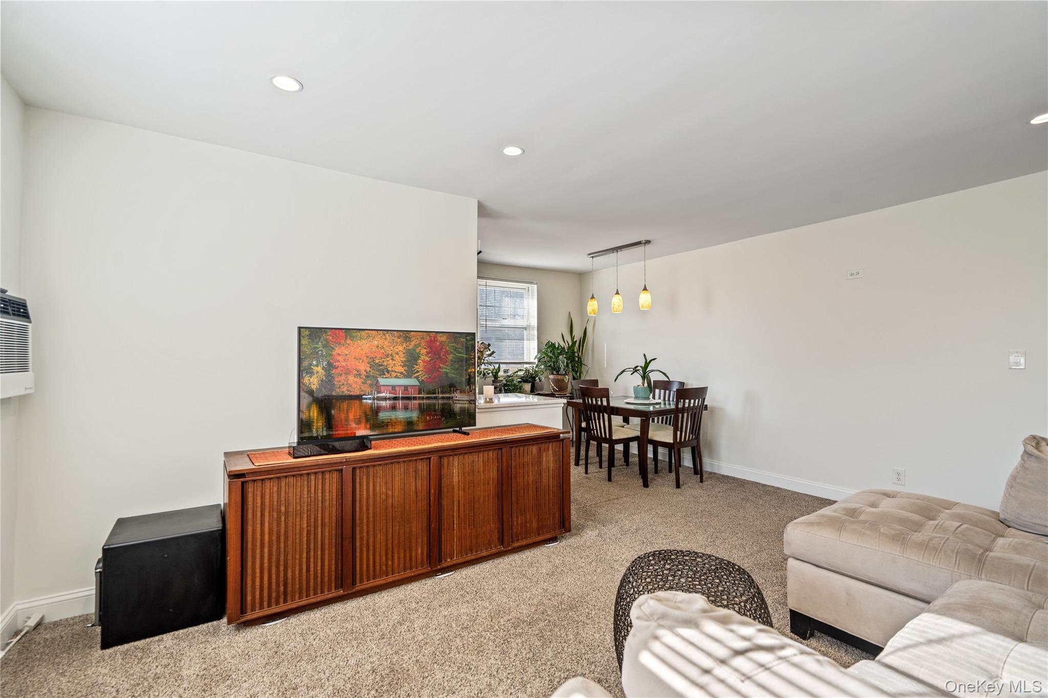 63-09 252nd Street, Unit 41322 Queens, NY 11362 - Photo 14 of 25 a living room with furniture and a flat screen tv