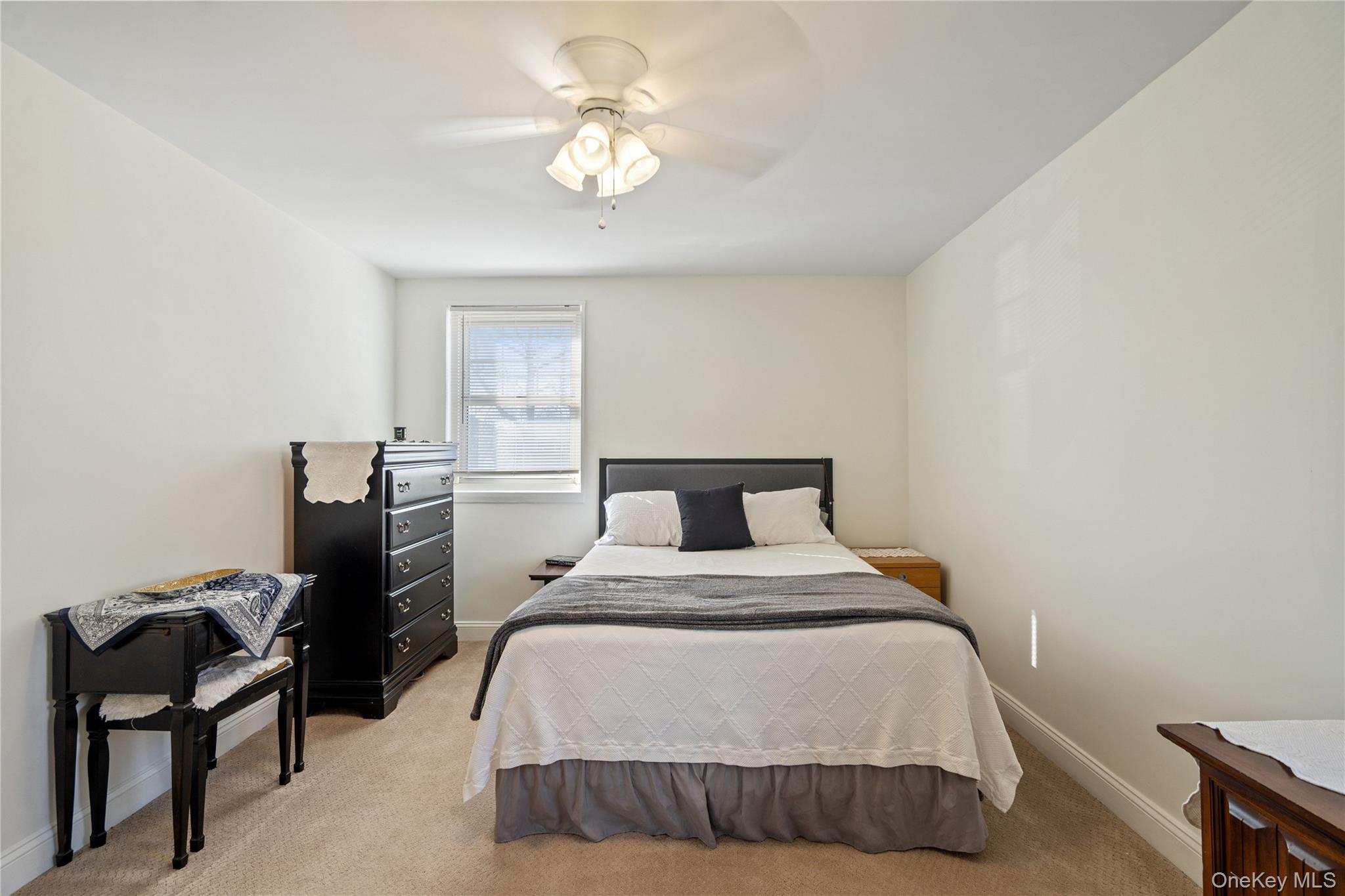 63-09 252nd Street, Unit 41322 Queens, NY 11362 - Photo 17 of 25 a bedroom with a bed and chair