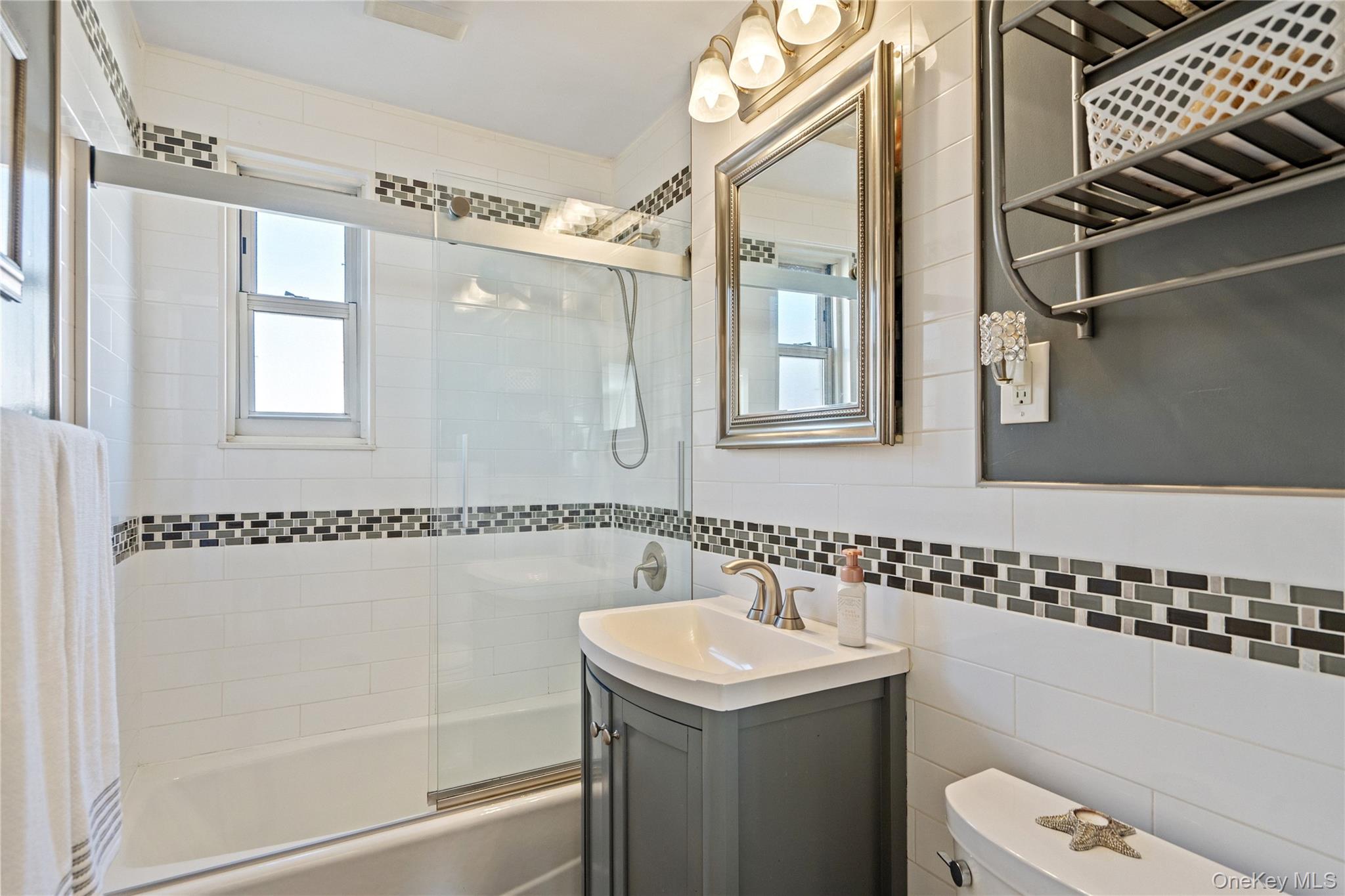 63-09 252nd Street, Unit 41322 Queens, NY 11362 - Photo 20 of 25 a bathroom with a sink a toilet and shower