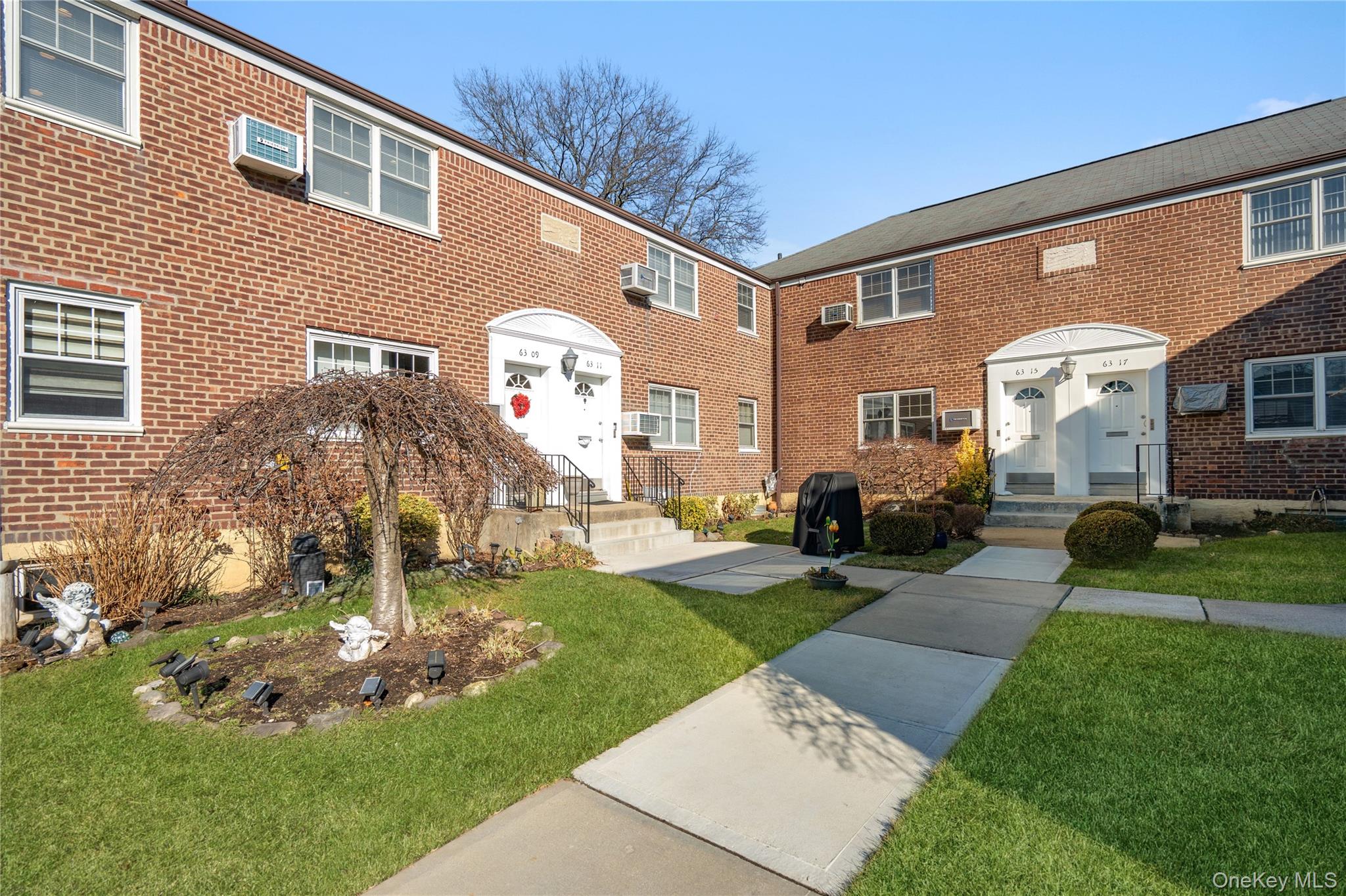 63-09 252nd Street, Unit 41322 Queens, NY 11362 - Photo 2 of 25 a front view of a house with garden