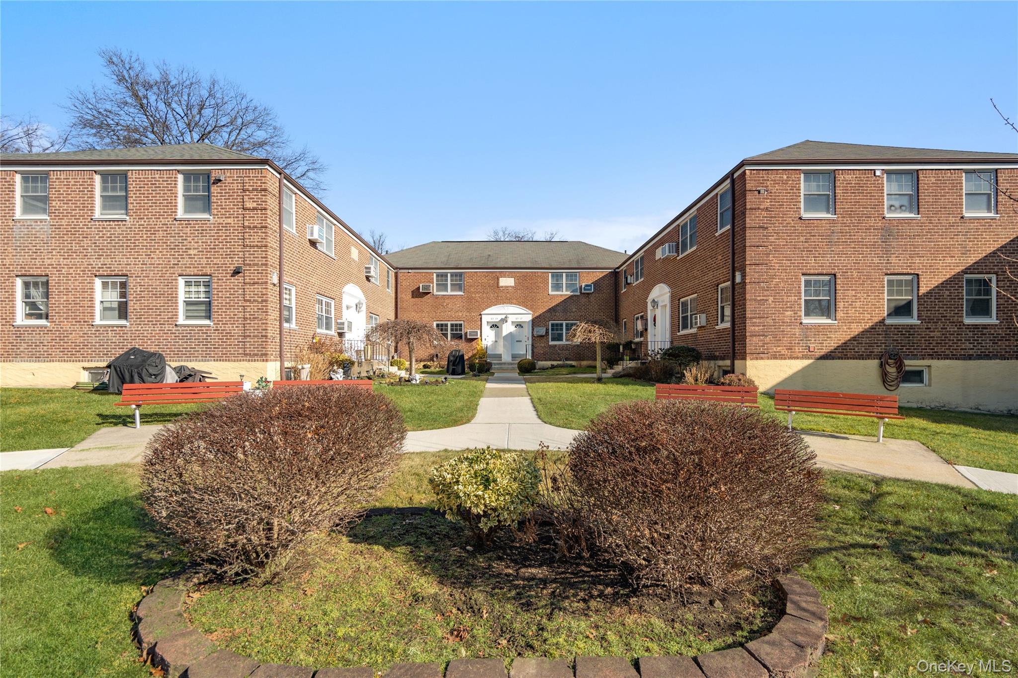 63-09 252nd Street, Unit 41322 Queens, NY 11362 - Photo 23 of 25 a front view of a house with a yard