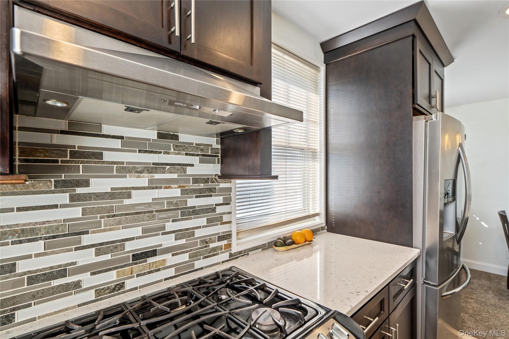 63-09 252nd Street, Unit 41322 Queens, NY 11362 - Photo 8 of 25 a kitchen with a stove and a refrigerator