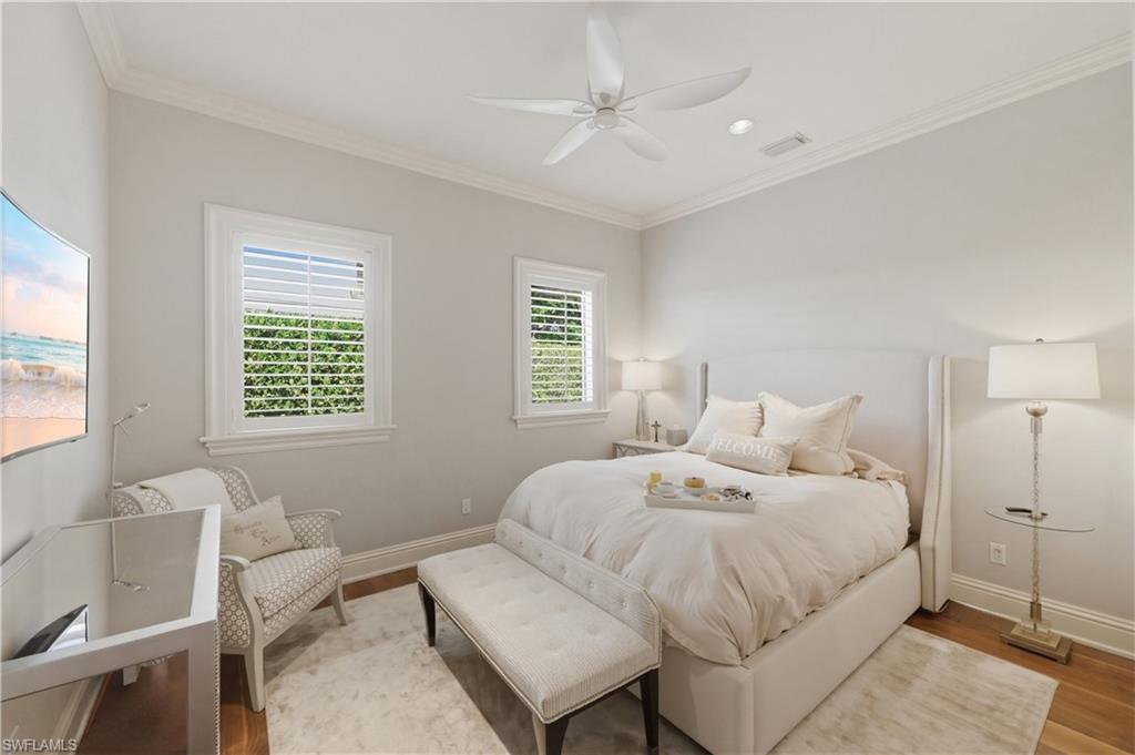 361 Pirates Bight Naples, FL 34103 - Photo 24 of 45 a bedroom with a bed and a chair