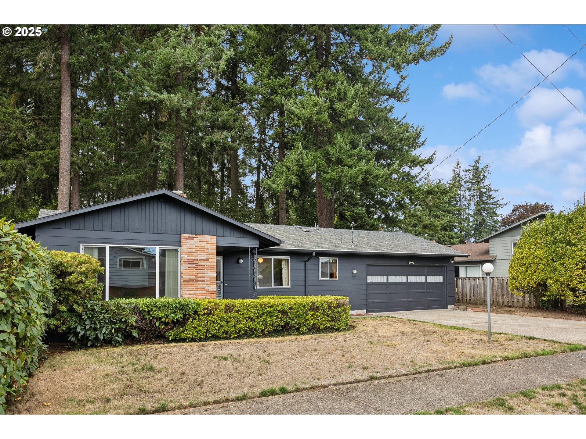 a front view of a house with a garden