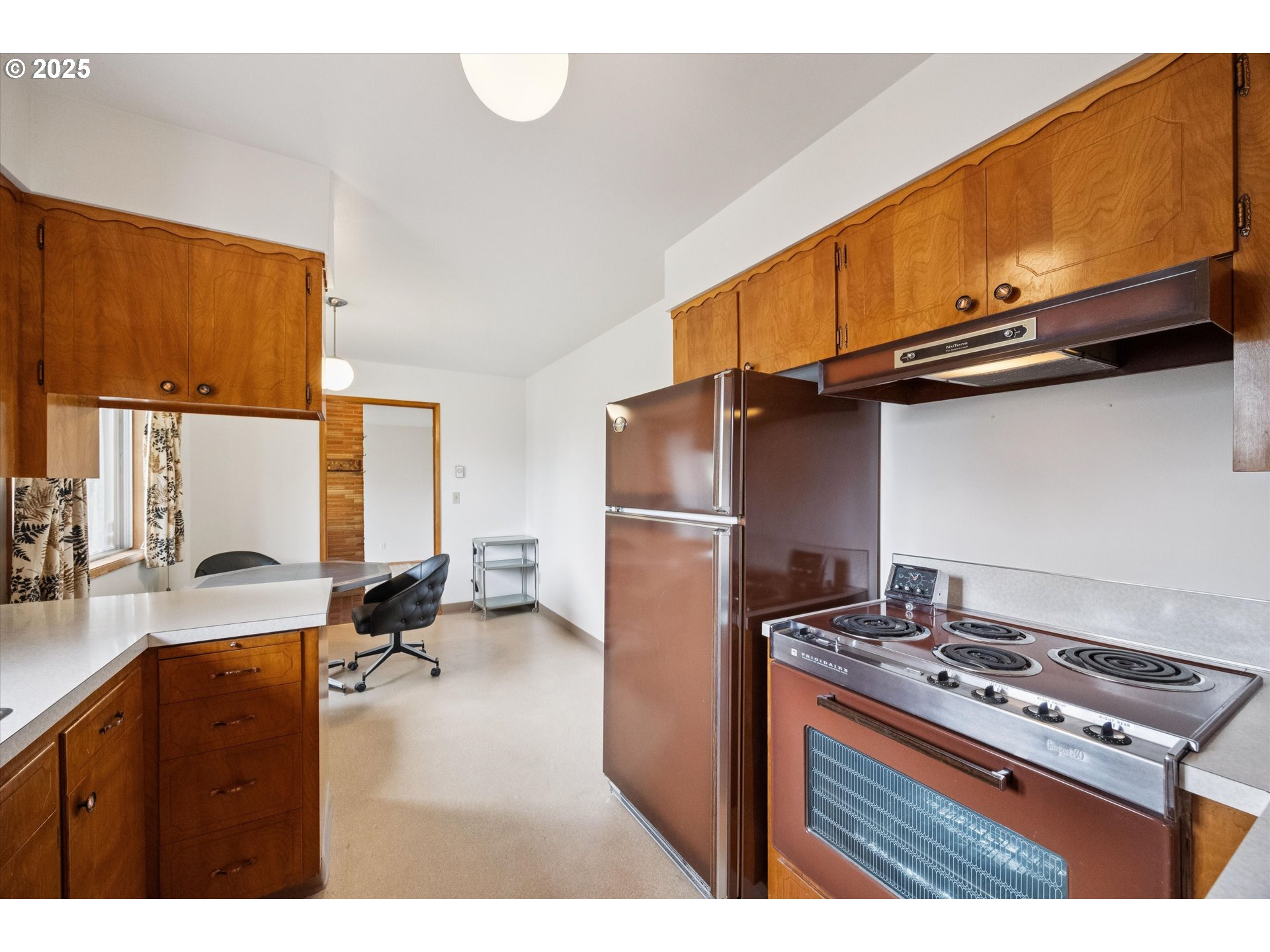 121 Southeast 166th Avenue Portland, OR 97233 - Photo 14 of 27 a kitchen with stainless steel appliances granite countertop a stove a sink dishwasher and cabinets with wooden floor