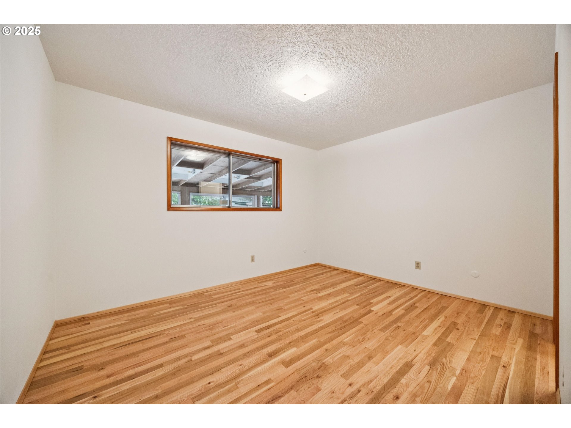 121 Southeast 166th Avenue Portland, OR 97233 - Photo 15 of 27 a view of empty room with wooden floor