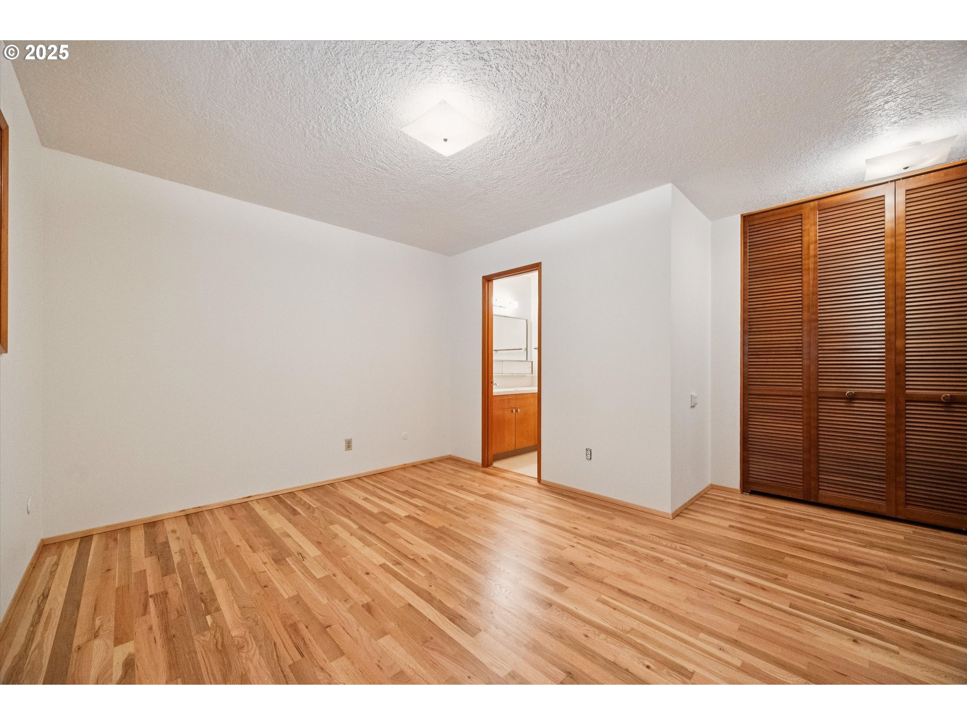 121 Southeast 166th Avenue Portland, OR 97233 - Photo 16 of 27 a view of an empty room with wooden floor
