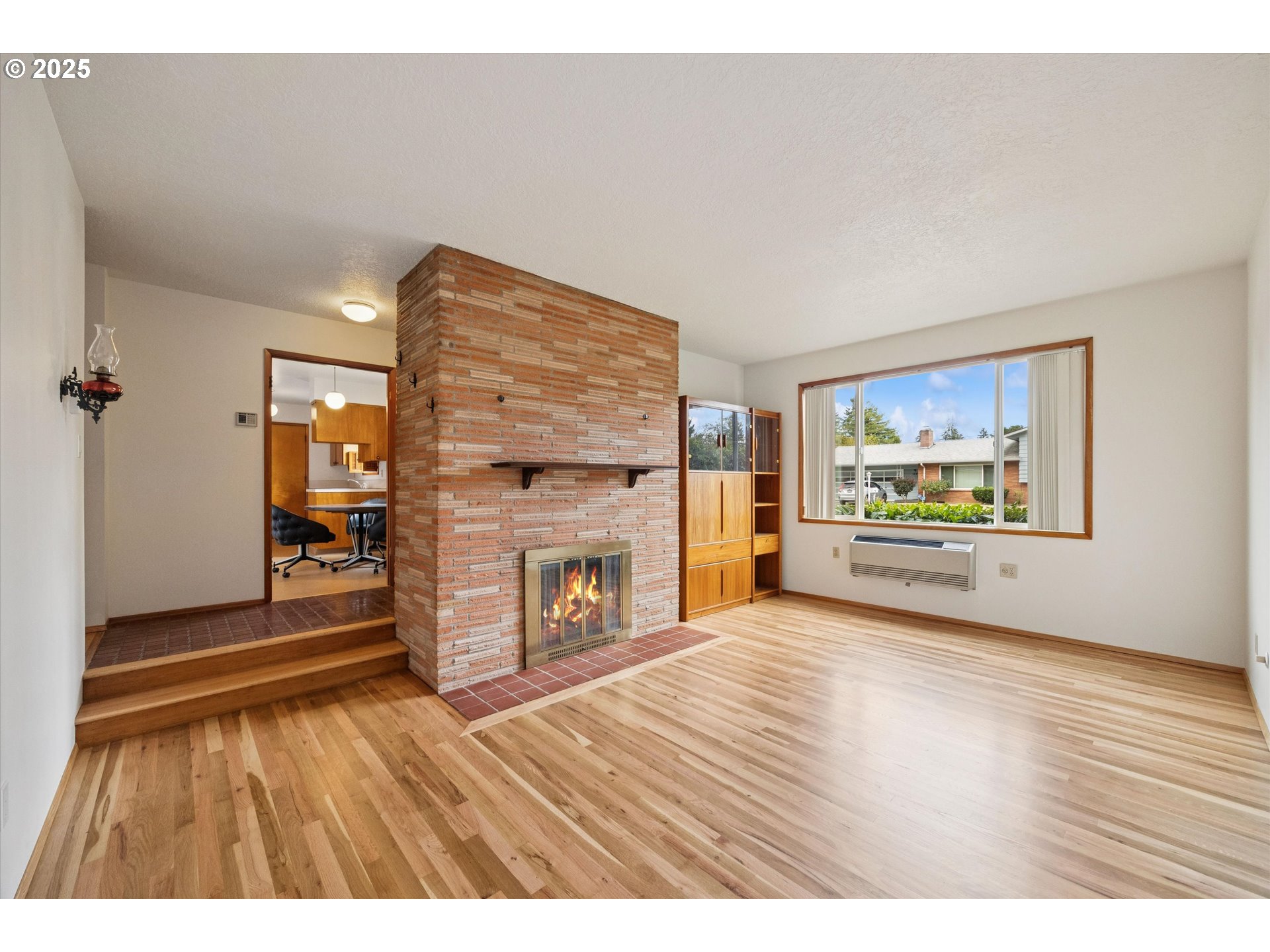 121 Southeast 166th Avenue Portland, OR 97233 - Photo 5 of 27 wooden floor in an empty room with a fireplace