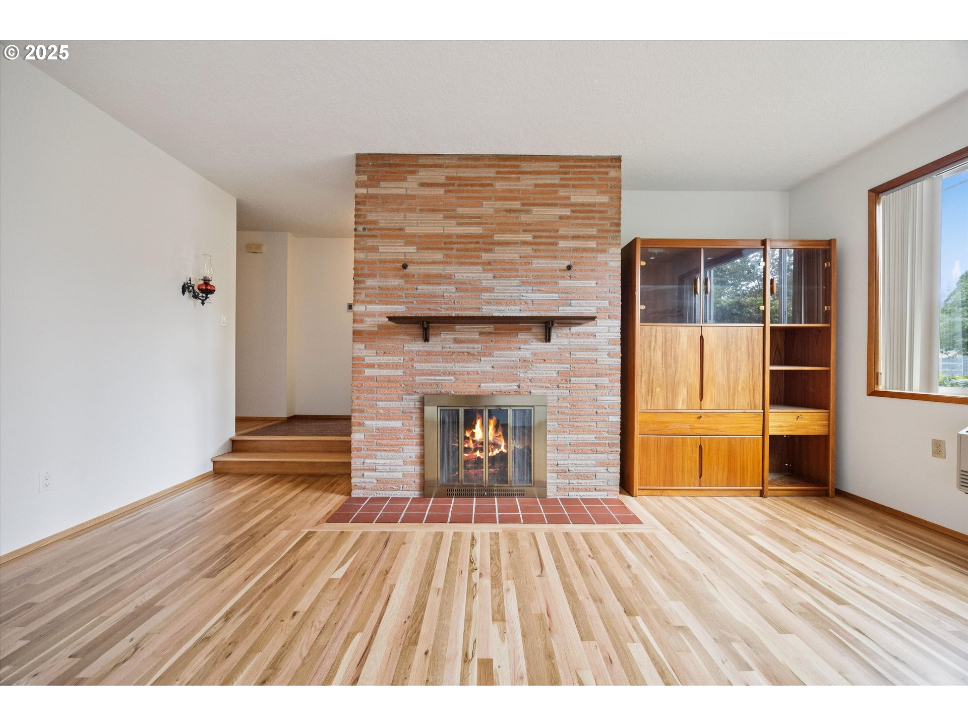 121 Southeast 166th Avenue Portland, OR 97233 - Photo 6 of 27 a view of empty room with wooden floor and fireplace