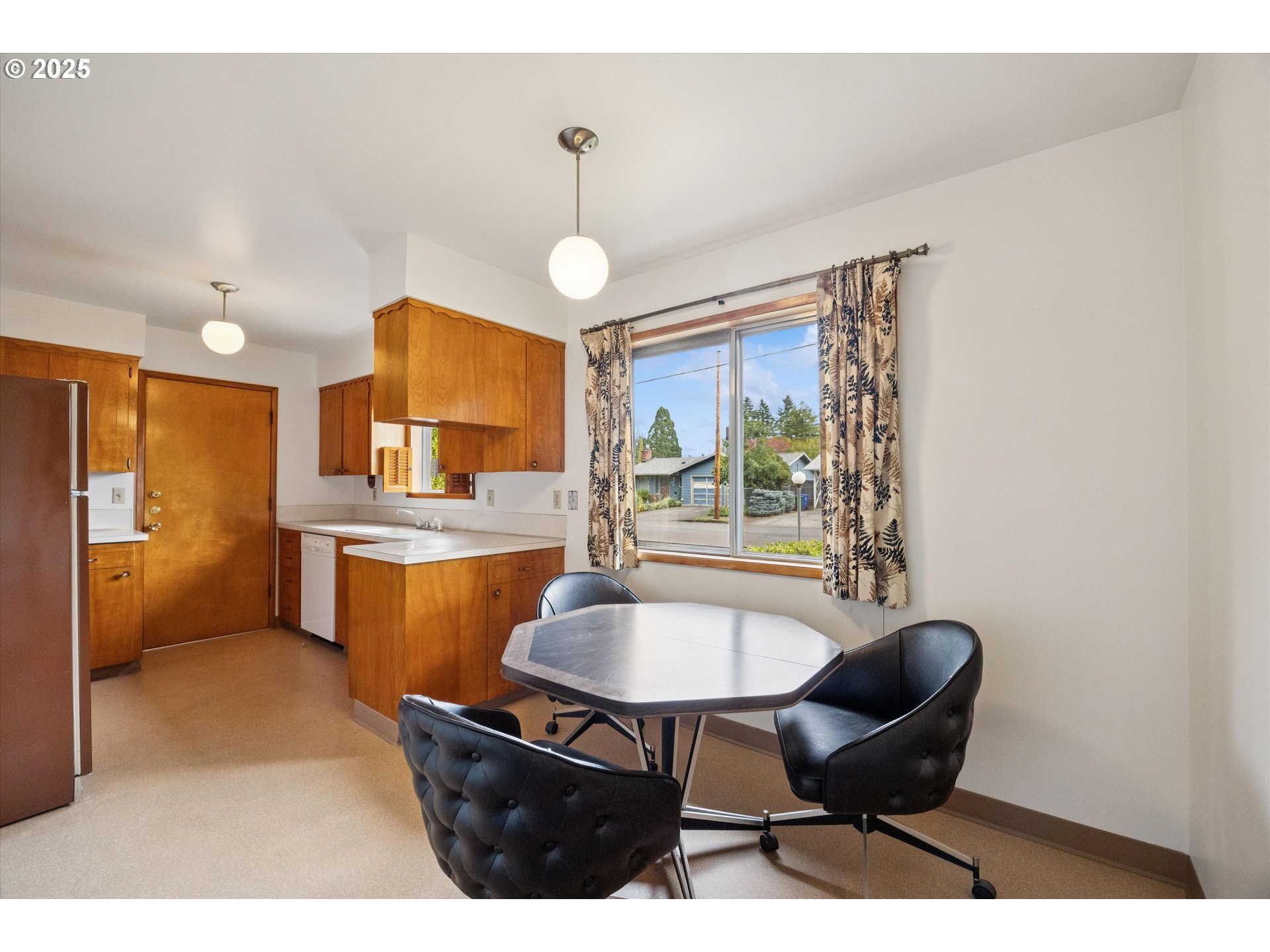 121 Southeast 166th Avenue Portland, OR 97233 - Photo 9 of 27 a living room with furniture a table and kitchen view