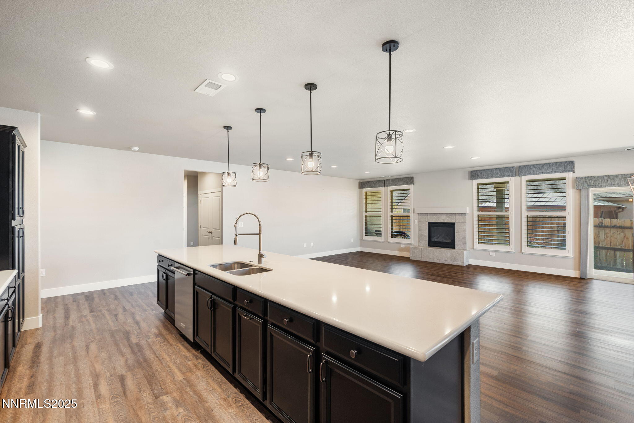 774 East Cottage Loop Gardnerville, NV 89460 - Photo 16 of 31 a kitchen with stainless steel appliances granite countertop a sink a oven a stove and a wooden floors