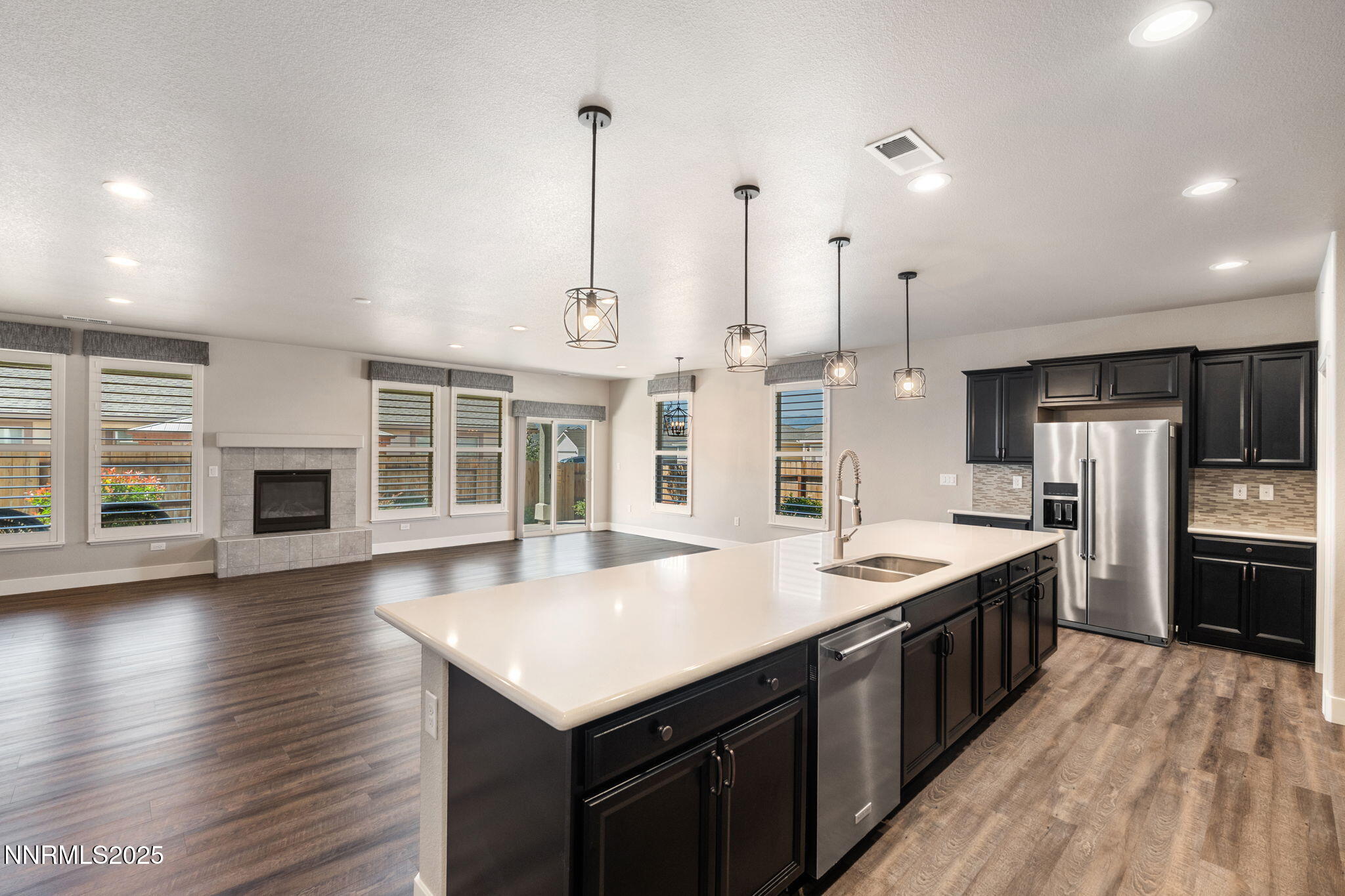 774 East Cottage Loop Gardnerville, NV 89460 - Photo 17 of 31 a kitchen with stainless steel appliances granite countertop a sink a stove and a wooden floors