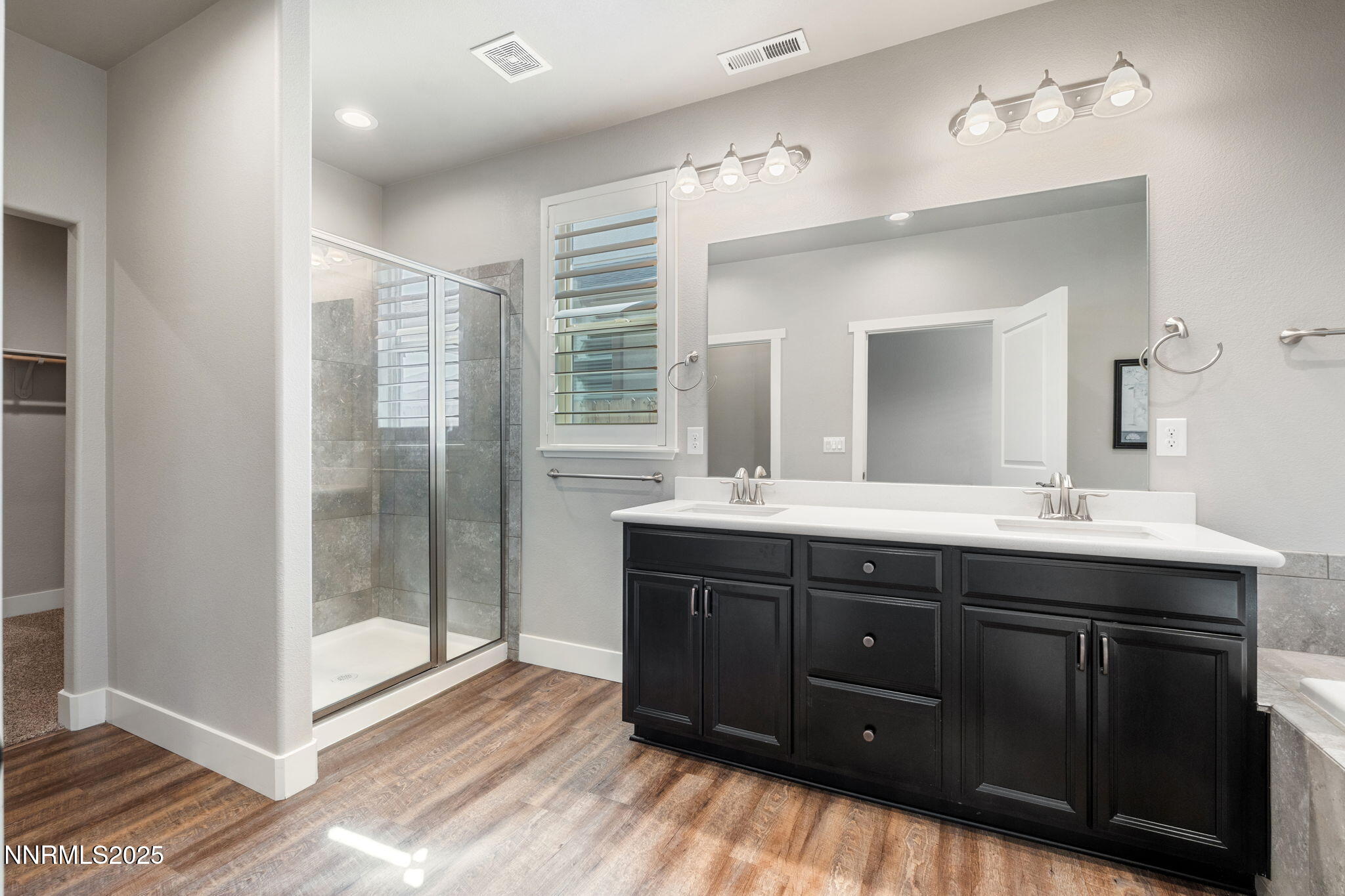 774 East Cottage Loop Gardnerville, NV 89460 - Photo 21 of 31 a spacious bathroom with a double vanity sink a mirror and a shower