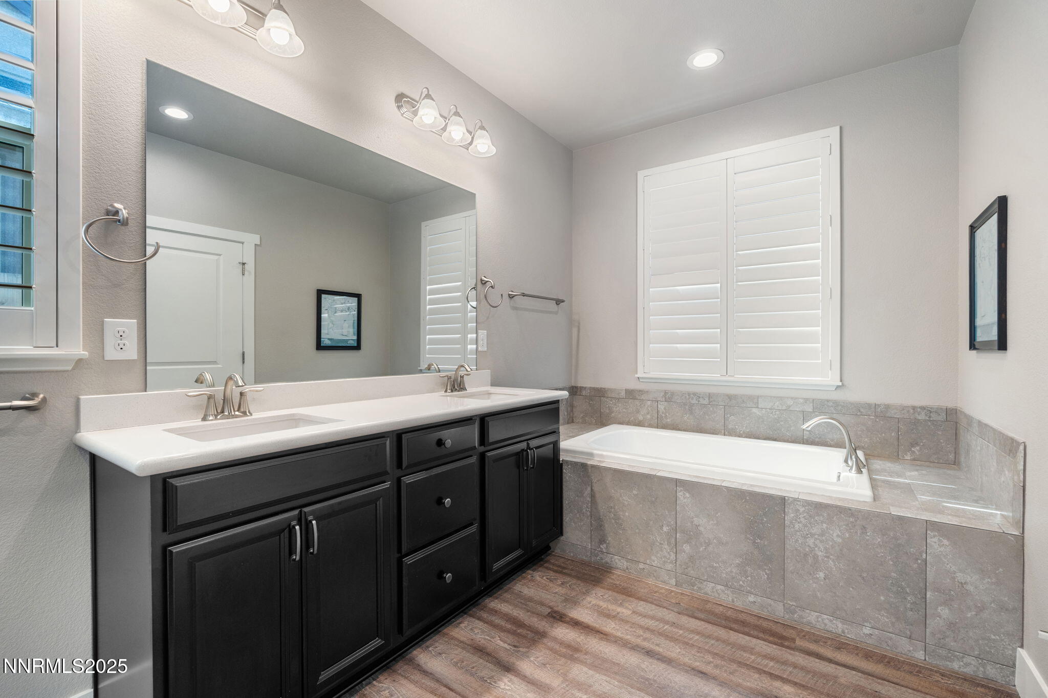 774 East Cottage Loop Gardnerville, NV 89460 - Photo 22 of 31 a bathroom with a tub double vanity sink and mirror