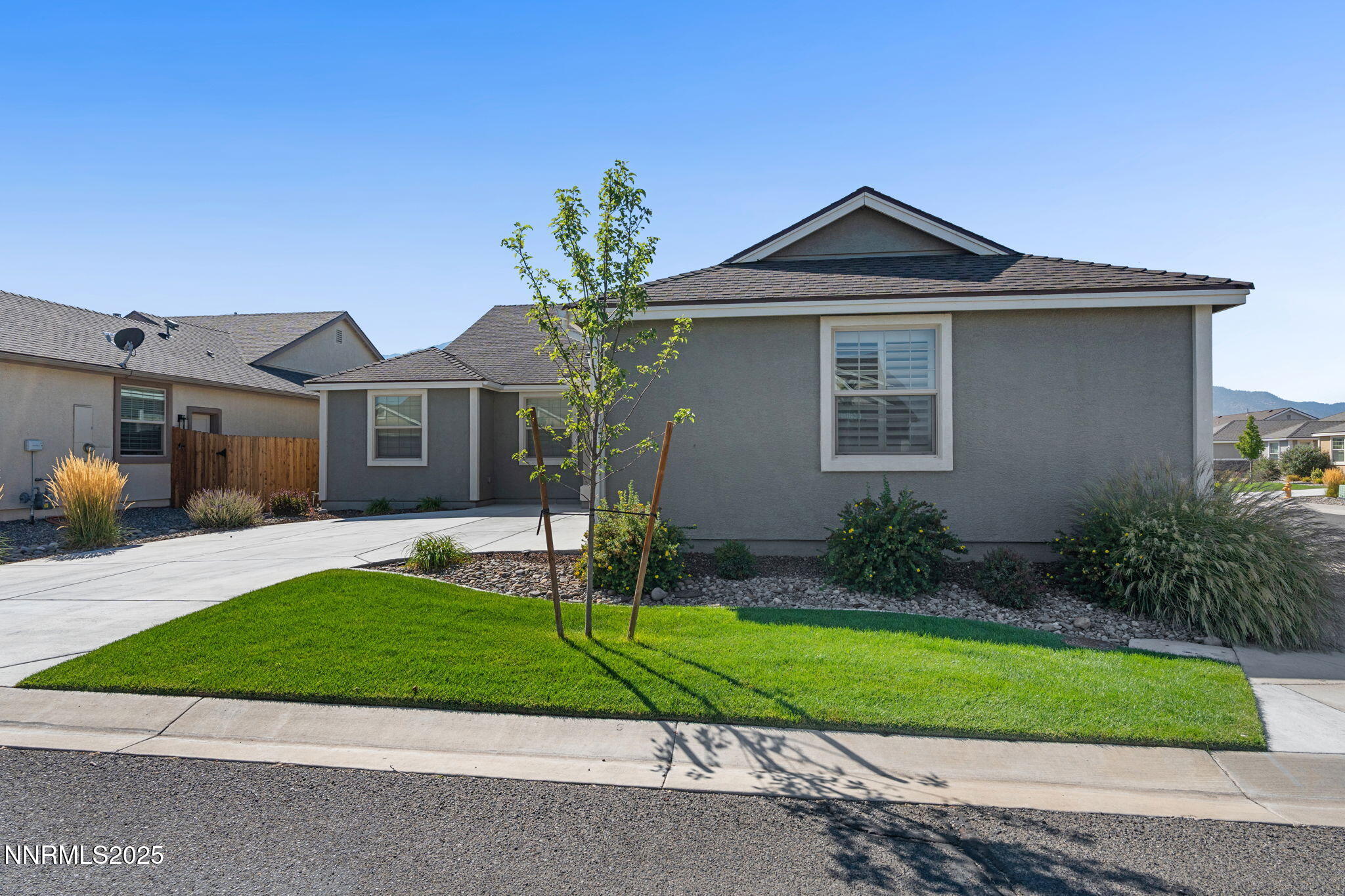774 East Cottage Loop Gardnerville, NV 89460 - Photo 4 of 31 a front view of a house with a yard and garage