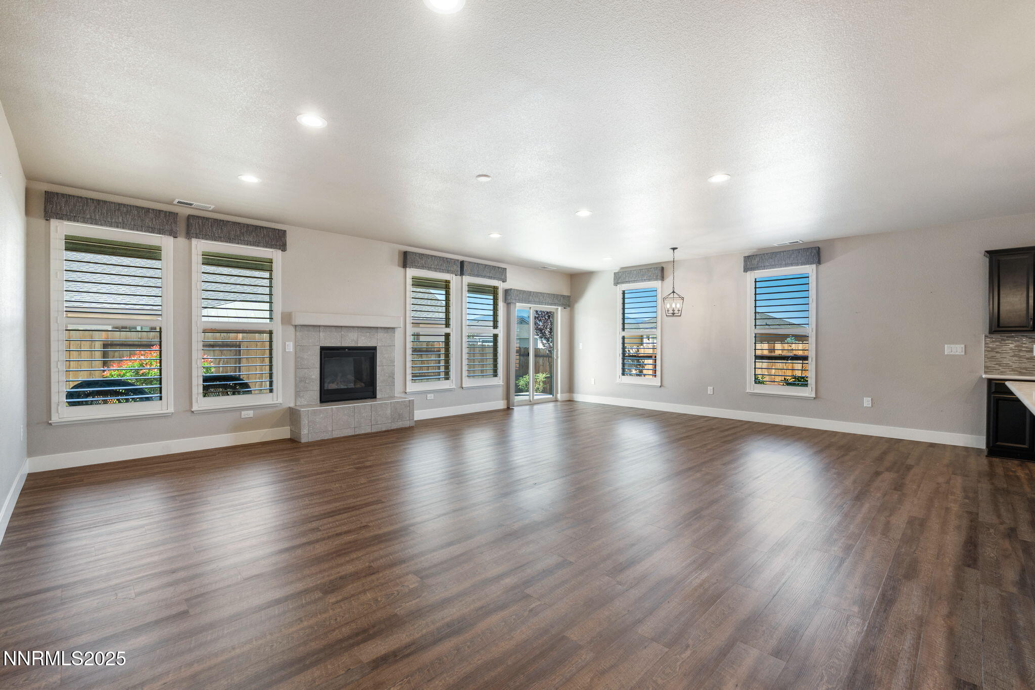 774 East Cottage Loop Gardnerville, NV 89460 - Photo 6 of 31 an empty room with wooden floor and fireplace