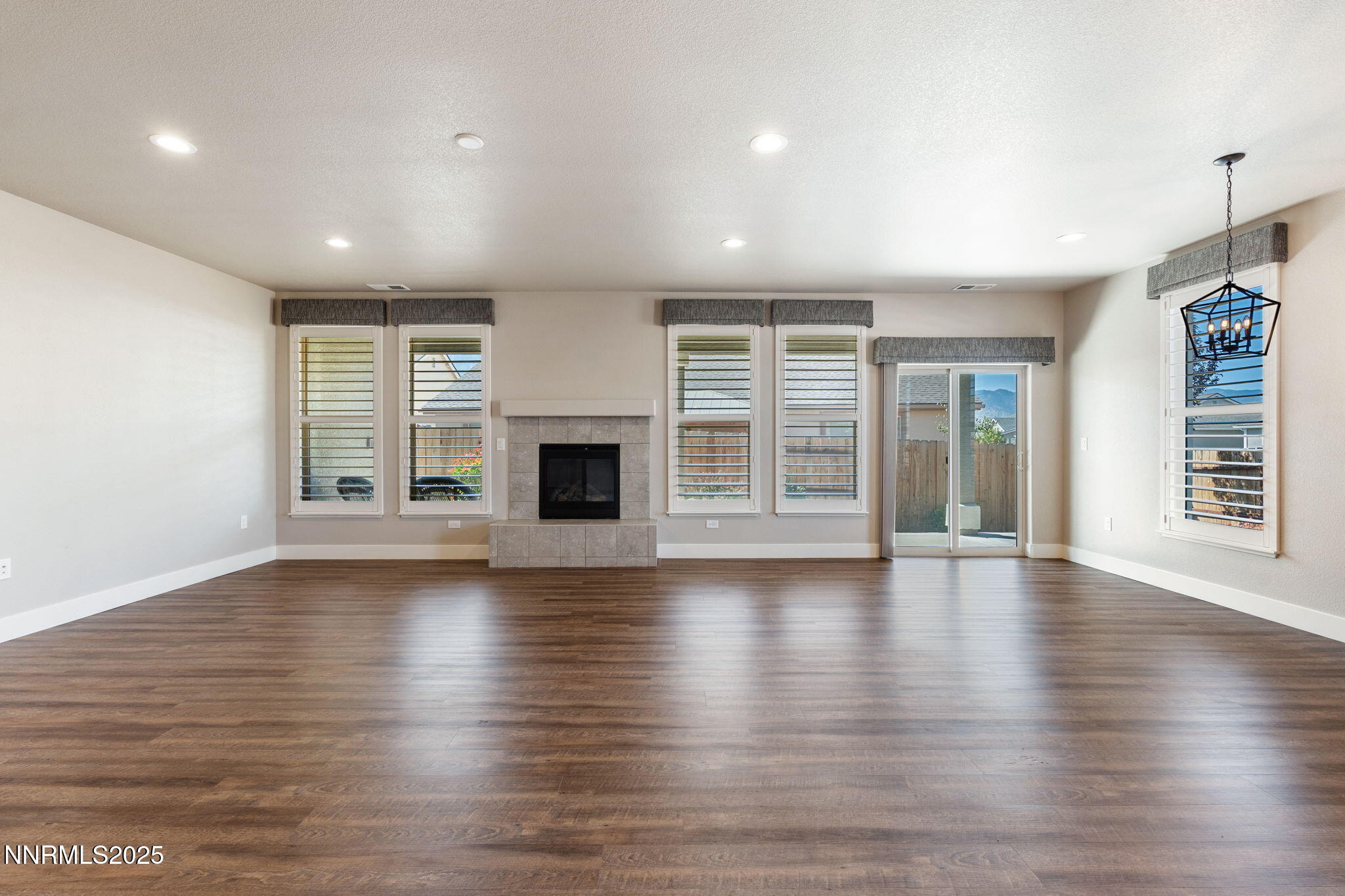 774 East Cottage Loop Gardnerville, NV 89460 - Photo 7 of 31 an empty room with wooden floor and fireplace