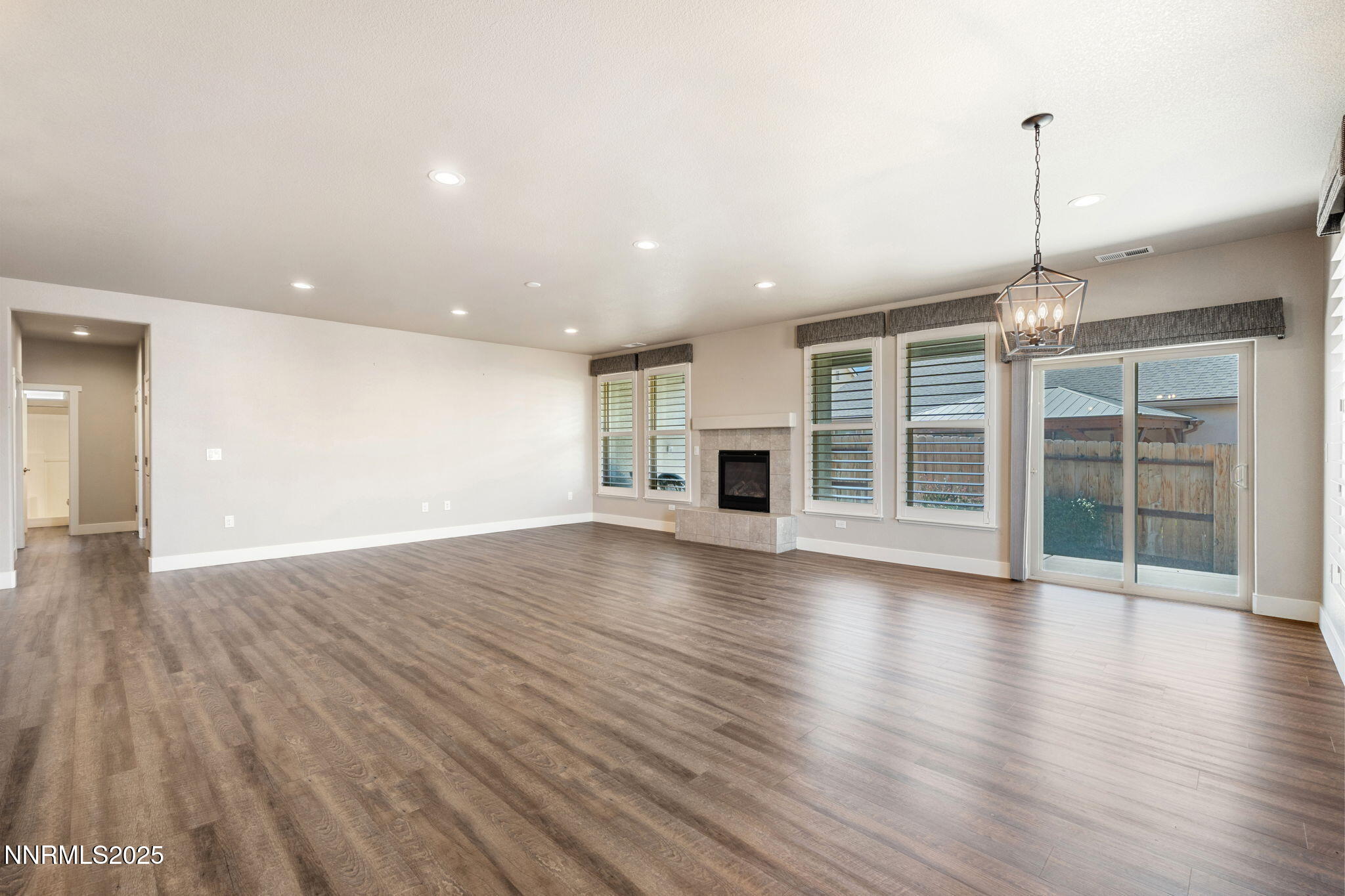 774 East Cottage Loop Gardnerville, NV 89460 - Photo 9 of 31 a view of empty room with wooden floor and fireplace