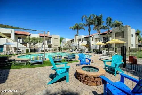 a swimming pool with outdoor seating and yard